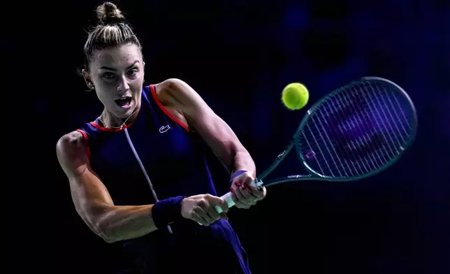 Romania's Jaqueline Cristian returns the ball against Japan's Ena Shibahara during the Billie Jean King Cup Finals, at the Martin Carpena Sports Hall, in Malaga, southern Spain, on Thursday, Nov. 14, 2024. (AP Photo/Manu Fernandez)