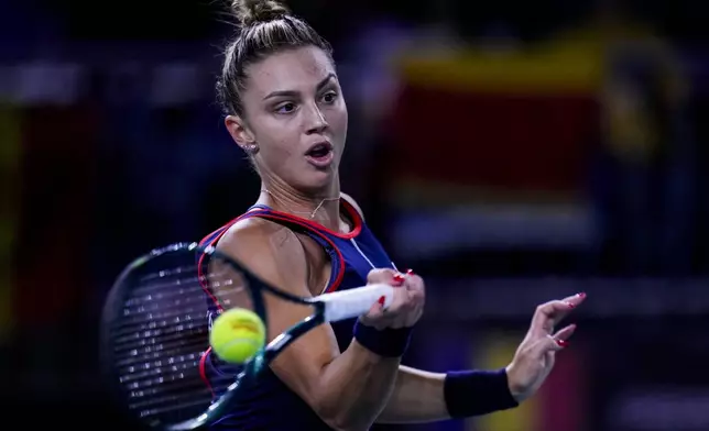 Romania's Jaqueline Cristian returns the ball against Japan's Ena Shibahara during the Billie Jean King Cup Finals, at the Martin Carpena Sports Hall, in Malaga, southern Spain, on Thursday, Nov. 14, 2024. (AP Photo/Manu Fernandez)