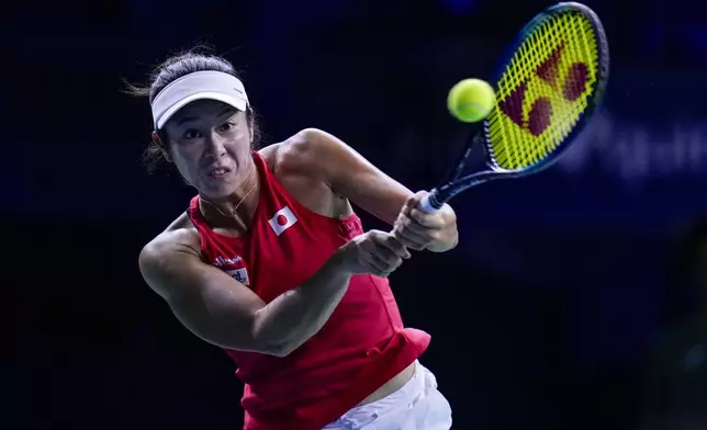 Japan's Ena Shibahara returns the ball against Romania's Jaqueline Cristian during the Billie Jean King Cup Finals, at the Martin Carpena Sports Hall, in Malaga, southern Spain, on Thursday, Nov. 14, 2024. (AP Photo/Manu Fernandez)