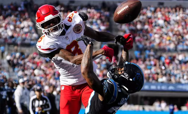 Carolina Panthers cornerback Dane Jackson (23) breaks up a pass intended for Kansas City Chiefs wide receiver DeAndre Hopkins (8) in the end zone during the first half of an NFL football game, Sunday, Nov. 24, 2024, in Charlotte, N.C. (AP Photo/Jacob Kupferman)