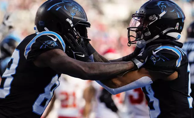 Carolina Panthers wide receiver David Moore, left, celebrates his touchdown against the Kansas City Chiefs during the second half of an NFL football game, Sunday, Nov. 24, 2024, in Charlotte, N.C. (AP Photo/Jacob Kupferman)