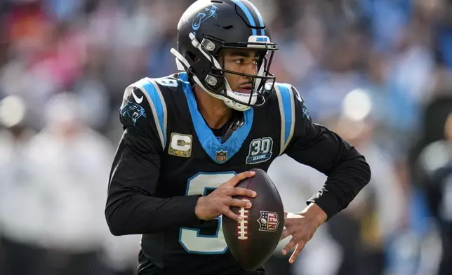 Carolina Panthers quarterback Bryce Young (9) runs out of the pocket against the Kansas City Chiefs during the first half of an NFL football game, Sunday, Nov. 24, 2024, in Charlotte, N.C. (AP Photo/Rusty Jones)