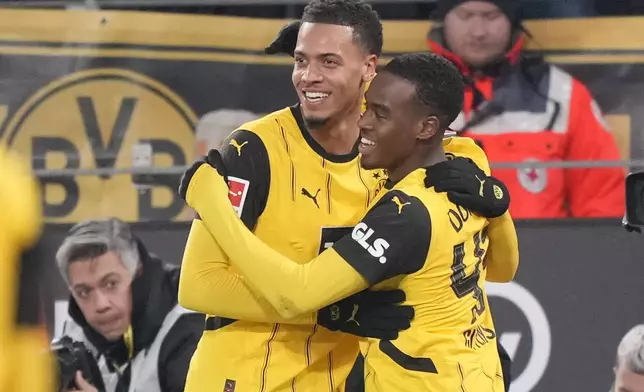 Dortmund's Jamie Bynoe-Gittens, right, celebrates after scoring with his teammate Felix Nmecha during the German Bundesliga soccer match between Borussia Dortmund and SC Freiburg at the Signal-Iduna Park in Dortmund, Germany, Saturday, Nov. 23, 2024. (AP Photo/Martin Meissner)