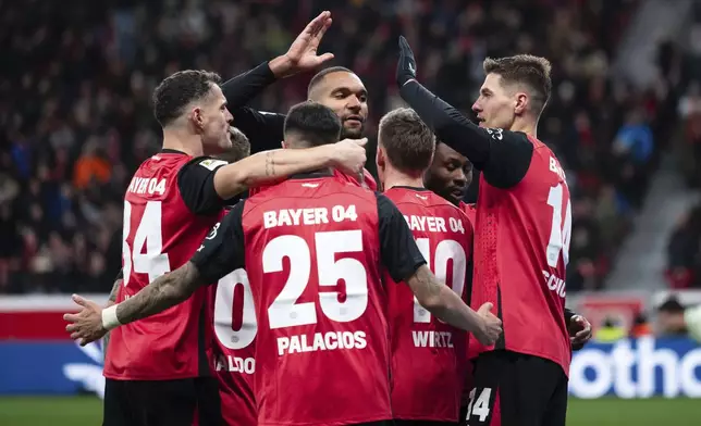 Leverkusen's scorer Patrik Schick, right, and his teammates celebrate their side's third goal during the German Bundesliga soccer match between Bayer 04 Leverkusen and 1. FC Heidenheim 1846 in Leverkusen, Germany, Saturday, Nov. 23, 2024. (Marius Becker/dpa via AP)