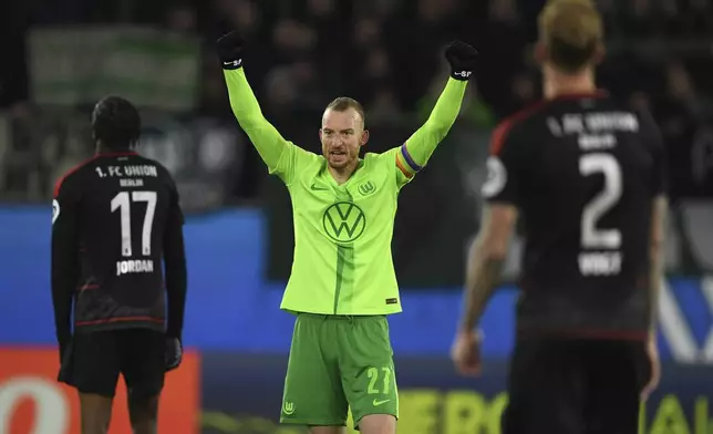 Wolfsburg's Maximilian Arnold, center, celebrates after the German Bundesliga soccer match between VfL Wolfsburg and 1. FC Union Berlin in Wolfsburg, Germany, Saturday, Nov. 23, 2024. (Swen Pfoertner/dpa via AP)