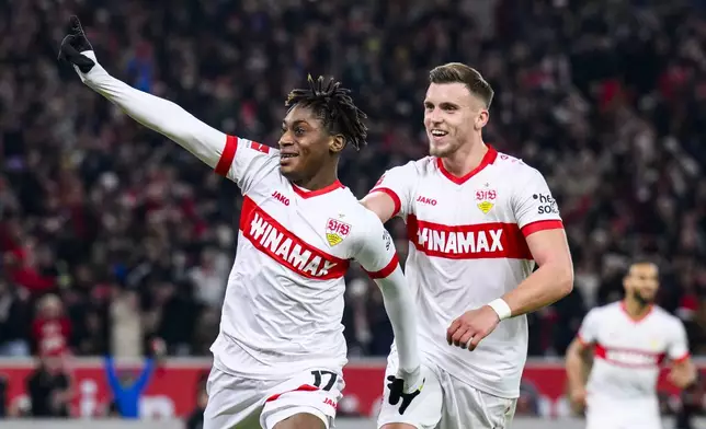 Stuttgart's scorer Justin Diehl, left, and his teammate Ermedin Demirovic, right, celebrate their side's second goal during the German Bundesliga soccer match between VfB Stuttgart and VfL Bochum in Stuttgart, Germany, Saturday, Nov. 23, 2024. (Tom Weller/dpa via AP)