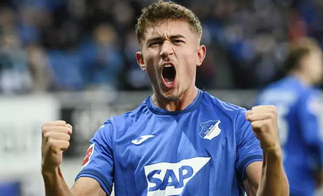 Hoffenheim's scorer Tom Bischof celebrates after scoring his side's second goal during the German Bundesliga soccer match between TSG 1899 Hoffenheim and RB Leipzig in Sinsheim, Germany, Saturday, Nov. 23, 2024. (Uwe Anspach/dpa via AP)