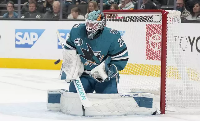 San Jose Sharks goaltender Mackenzie Blackwood blocks a shot against the Buffalo Sabres during the second period of an NHL hockey game in San Jose, Calif., Saturday, Nov. 23, 2024. (AP Photo/Tony Avelar)