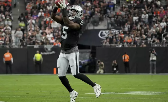 Las Vegas Raiders linebacker Divine Deablo (5) catches a fake punt during the first half of an NFL football game against the Denver Broncos, Sunday, Nov. 24, 2024, in Las Vegas. (AP Photo/Rick Scuteri)