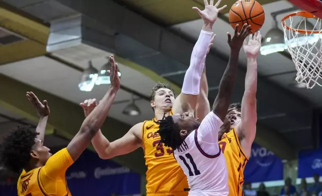 Dayton guard Malachi Smith (11) goes to the basket against Iowa State guard Curtis Jones, left, forward Brandton Chatfield, center, and guard Nate Heise, back right, during the second half of an NCAA college basketball game at the Maui Invitational Tuesday, Nov. 26, 2024, in Lahaina, Hawaii. Iowa State won 89-84. (AP Photo/Lindsey Wasson)