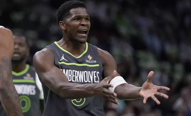 Minnesota Timberwolves guard Anthony Edwards (5) reacts toward a referee during the first half of an Emirates NBA cup basketball game against the Houston Rockets, Tuesday, Nov. 26, 2024, in Minneapolis. (AP Photo/Abbie Parr)