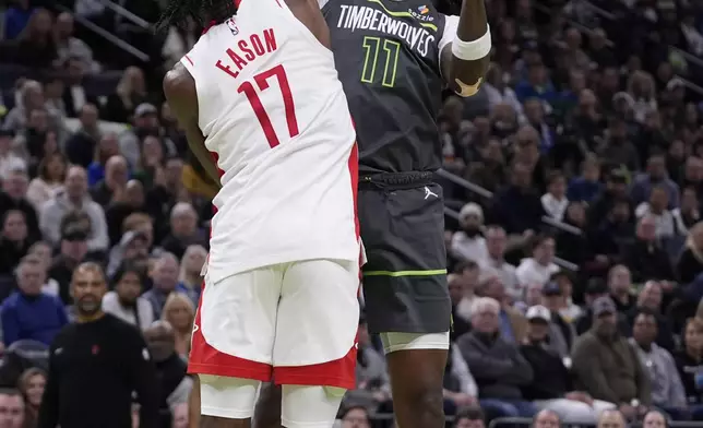 Houston Rockets forward Tari Eason (17) blocks a shot by Minnesota Timberwolves center Naz Reid (11) during the first half of an Emirates NBA cup basketball game, Tuesday, Nov. 26, 2024, in Minneapolis. (AP Photo/Abbie Parr)