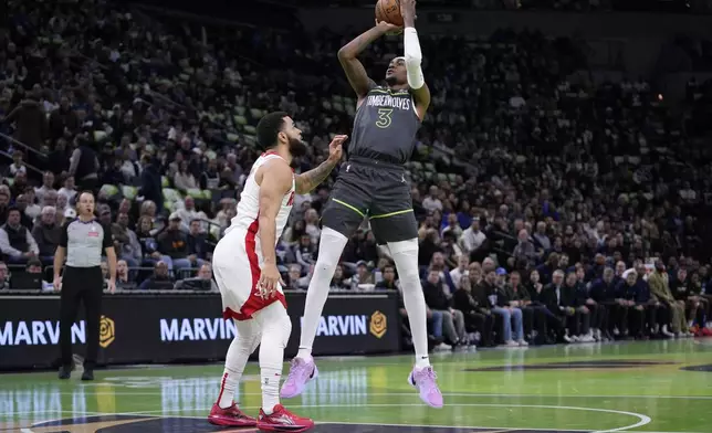 Minnesota Timberwolves forward Jaden McDaniels (3) shoots over Houston Rockets guard Fred VanVleet (5) during the first half of an Emirates NBA cup basketball game, Tuesday, Nov. 26, 2024, in Minneapolis. (AP Photo/Abbie Parr)