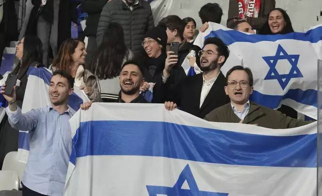 Israeli supporters display their national flag before the UEFA Nations League soccer match between France and Israel at the Stade de France stadium in Saint-Denis, outside Paris, Thursday Nov. 14, 2024. (AP Photo/Michel Euler)