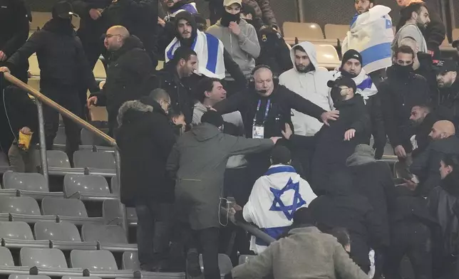 Fans argue on stands during the UEFA Nations League soccer match between France and Israel at the Stade de France stadium in Saint-Denis, outside Paris, Thursday Nov. 14, 2024. (AP Photo/Thibault Camus)