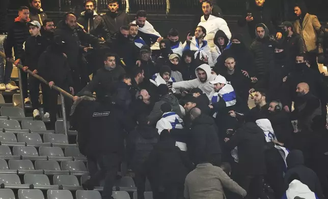 Fans argue on stands during the UEFA Nations League soccer match between France and Israel at the Stade de France stadium in Saint-Denis, outside Paris, Thursday Nov. 14, 2024. (AP Photo/Thibault Camus)