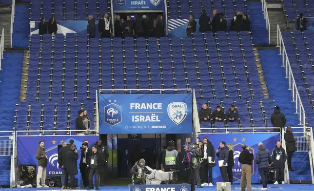 Spectators arrive before the UEFA Nations League soccer match between France and Israel at the Stade de France stadium in Saint-Denis, outside Paris, Thursday Nov. 14, 2024. (AP Photo/Michel Euler)