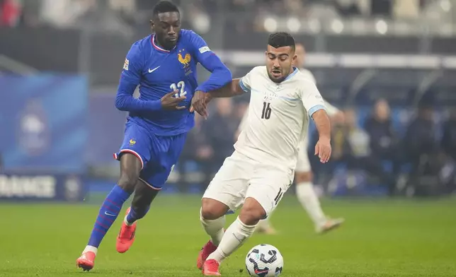 France's Randal Kolo Muani, left, and Israel's Mohammad Abu Fani compete for the ball during the UEFA Nations League soccer match between France and Israel at the Sea de de France stadium in Saint-Denis, outside Paris, Thursday Nov. 14, 2024. (AP Photo/Michel Euler)