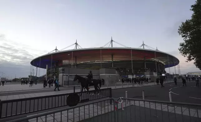 A mounted police officer patrols past the stadium ahead of the Nations League soccer match France against Israel outside the Stade de France stadium, Thursday, Nov. 14, 2024 in Saint-Denis, outside Paris. (AP Photo/Aurelien Morissard)