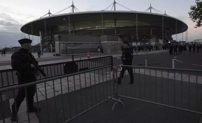 Police officers patrol in front of the stadium ahead of the Nations League soccer match France against Israel outside the Stade de France stadium, Thursday, Nov. 14, 2024 in Saint-Denis, outside Paris. (AP Photo/Aurelien Morissard)