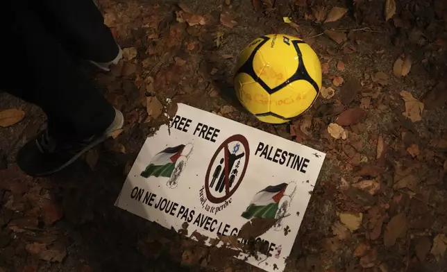 A soccer ball and a spotter are pictured during a rally in support of the Palestinian people, ahead of the Nations League soccer match France against Israel, Thursday, Nov. 14, 2024 in Saint-Denis, outside Paris. (AP Photo/Christophe Ena)