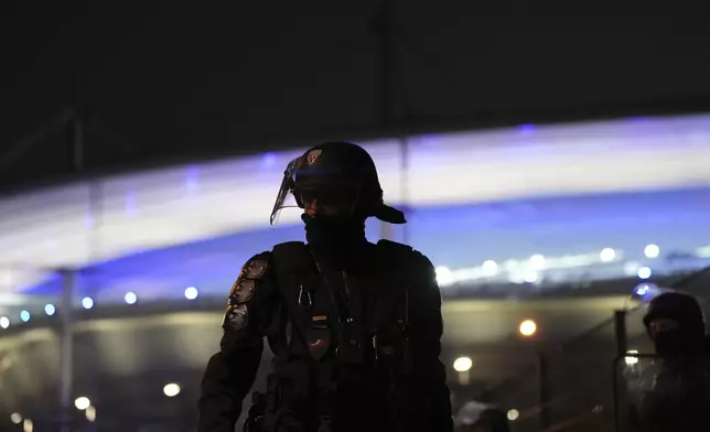 A riot police officer stands outside the Stade de France stadium ahead of the Nations League soccer match France against Israel , Thursday, Nov. 14, 2024 in Saint-Denis, outside Paris. (AP Photo/Aurelien Morissard)