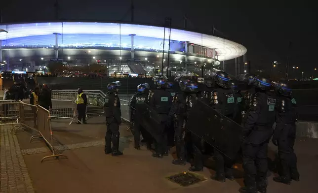 Police officers take position ahead of the Nations League soccer match France against Israel outside the Stade de France stadium, Thursday, Nov. 14, 2024 in Saint-Denis, outside Paris. (AP Photo/Aurelien Morissard)