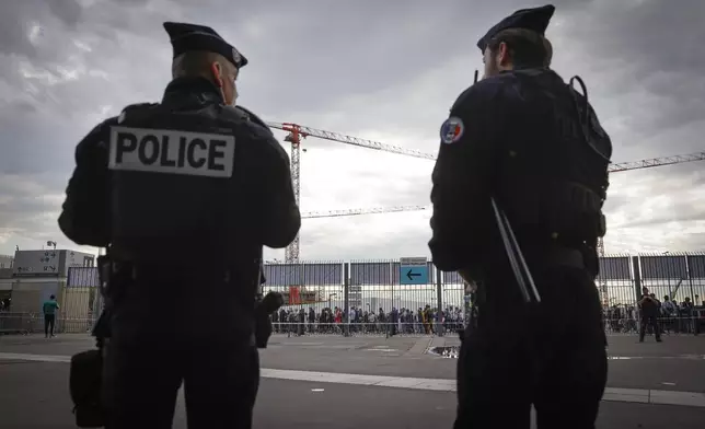 FILE - Police officers stand guard ahead the UEFA Nations League soccer match between France and Denmark at the Stade de France in Saint Denis near Paris, France, Friday, June 3, 2022. (AP Photo/Jean-Francois Badias, File)