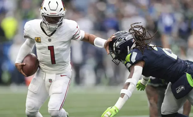 Arizona Cardinals quarterback Kyler Murray (1) tries to get past Seattle Seahawks safety Rayshawn Jenkins (2) during the first half of an NFL football game Sunday, Nov. 24, 2024, in Seattle. (AP Photo/Jason Redmond)