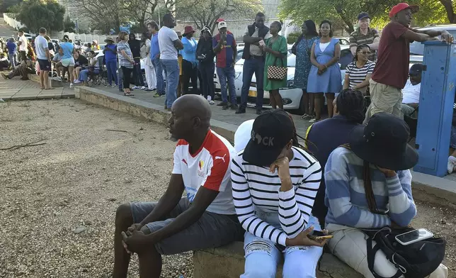 Namibians queue to cast their votes in a presidential election in Windhoek, Namibia Wednesday, Nov. 27, 2024. (AP Photo/Dirk Heinrich)