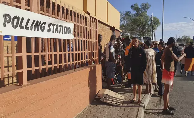 Namibians queue to cast their votes in a presidential election in Windhoek, Namibia Wednesday, Nov. 27, 2024. (AP Photo/Dirk Heinrich)