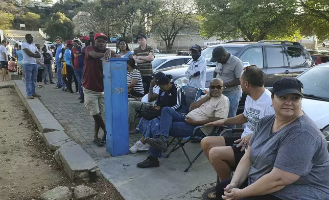 Namibians queue to cast their votes in a presidential election in Windhoek, Namibia Wednesday, Nov. 27, 2024. (AP Photo/Dirk Heinrich)