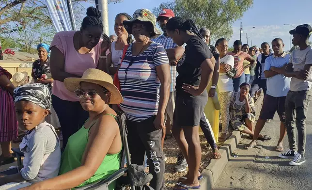 Namibians queue to cast their votes in a presidential election in Windhoek, Namibia Wednesday, Nov. 27, 2024. (AP Photo/Dirk Heinrich)