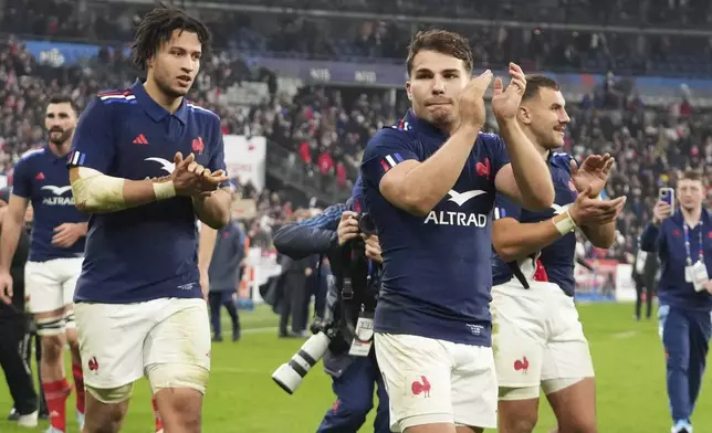 France's Antoine Dupont celebrates with teammates following the Autumn Nations series rugby union match between France and All Blacks at the Stade de France stadium, in Saint-Denis, outside Paris, Saturday, Nov. 16, 2024. (AP Photo/Michel Euler)