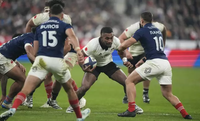 New Zealand's Sevu Reece runs at the defence during the Autumn Nations series rugby union match between France and All Blacks at the Stade de France stadium, in Saint-Denis, outside Paris, Saturday, Nov. 16, 2024. (AP Photo/Michel Euler)