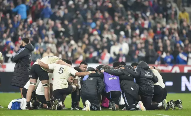 New Zealand players embrace following the Autumn Nations series rugby union match between France and All Blacks at the Stade de France stadium, in Saint-Denis, outside Paris, Saturday, Nov. 16, 2024. (AP Photo/Michel Euler)