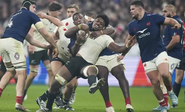 New Zealand's Peter Lakai is tackled as he runs at the defence during the Autumn Nations series rugby union match between France and All Blacks at the Stade de France stadium, in Saint-Denis, outside Paris, Saturday, Nov. 16, 2024. (AP Photo/Michel Euler)