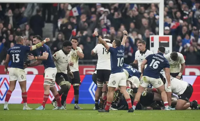 French players celebrate following the Autumn Nations series rugby union match between France and All Blacks at the Stade de France stadium, in Saint-Denis, outside Paris, Saturday, Nov. 16, 2024. (AP Photo/Michel Euler)