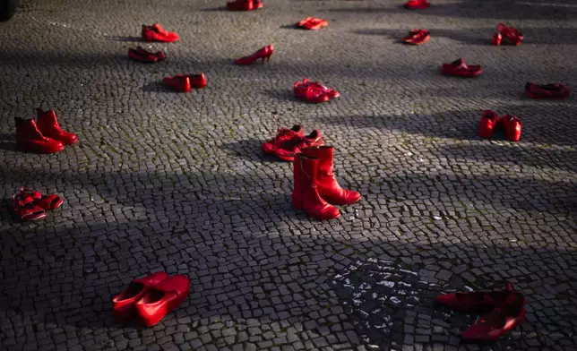 Red shoes placed on the ground as a symbol against the violence on women, during a rally marking the International Day for the Elimination of Violence Against Women, in Berlin, Germany, Monday, Nov. 25, 2024. (AP Photo/Markus Schreiber)