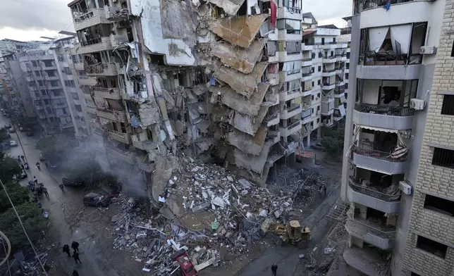 Bulldozers remove the rubble of a destroyed building that was hit Sunday night in an Israeli airstrike in Dahiyeh, in the southern suburb of Beirut, Lebanon, Monday, Nov. 25, 2024. (AP Photo/Hussein Malla)