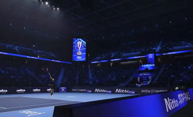 United States' Taylor Fritz serves the ball to Australia's Alex de Minaur during their singles tennis match of the ATP World Tour Finals at the Inalpi Arena, in Turin, Italy, Thursday, Nov. 14, 2024. (AP Photo/Antonio Calanni)