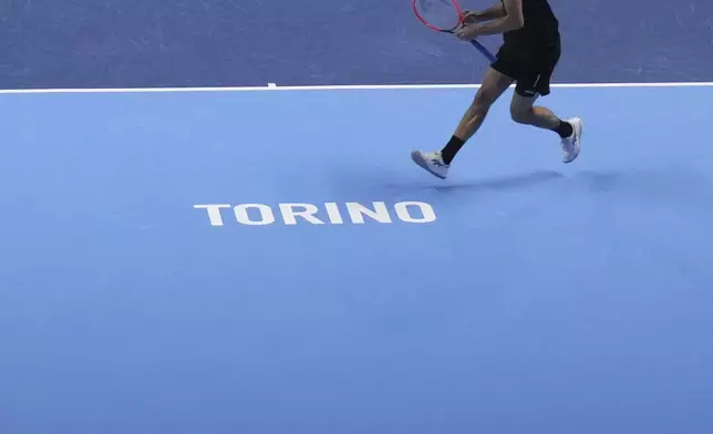 United States' Taylor Fritz returns the ball to Australia's Alex de Minaur during their singles tennis match of the ATP World Tour Finals at the Inalpi Arena, in Turin, Italy, Thursday, Nov. 14, 2024. (AP Photo/Antonio Calanni)