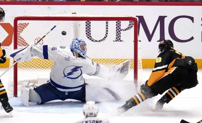 Pittsburgh Penguins' Jesse Puljujarvi, right, gets a shot past Tampa Bay Lightning goaltender Andrei Vasilevskiy for a goal during the first period of an NHL hockey game Tuesday, Nov. 19, 2024, in Pittsburgh. (AP Photo/Gene J. Puskar)