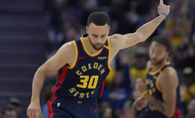 Golden State Warriors guard Stephen Curry reacts after scoring against the Atlanta Hawks during the first half of an NBA basketball game Wednesday, Nov. 20, 2024, in San Francisco. (AP Photo/Godofredo A. Vásquez)