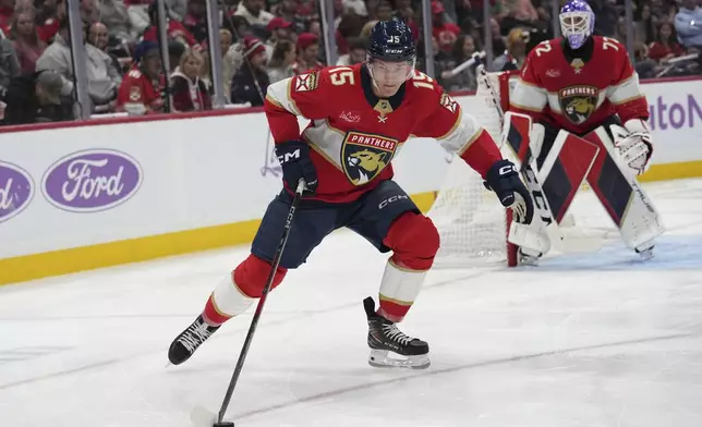 Florida Panthers center Anton Lundell (15) skates with he puck during the first period of an NHL hockey game against the Winnipeg Jets, Saturday, Nov. 16, 2024, in Sunrise, Fla. (AP Photo/Lynne Sladky)