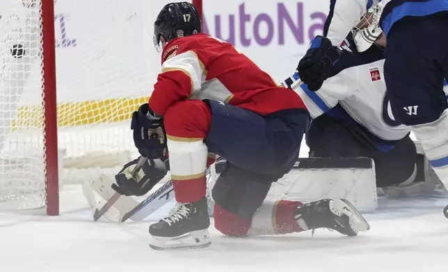 Florida Panthers center Evan Rodrigues, left, scores during the second period of an NHL hockey game against the Winnipeg Jets, Saturday, Nov. 16, 2024, in Sunrise, Fla. (AP Photo/Lynne Sladky)