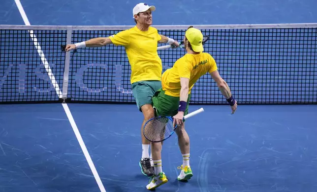 Australia's Matthew Ebden, left, and Jordan Thompson celebrate their victory against Tommy Paul and Ben Shelton of the United States, during their doubles tennis quarterfinal Davis Cup match at the Martin Carpena Sports Hall, in Malaga, southern Spain, on Thursday, Nov. 21, 2024. (AP Photo/Manu Fernandez)