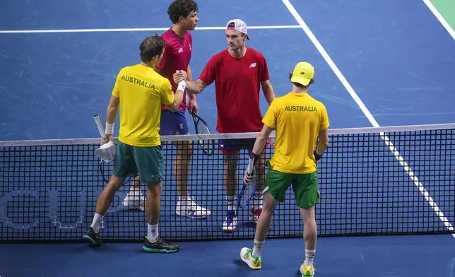 Australia's Matthew Ebden, left, and Jordan Thompson shake hands after defeating Tommy Paul and Ben Shelton of the United States during their doubles tennis quarterfinal Davis Cup match at the Martin Carpena Sports Hall, in Malaga, southern Spain, on Thursday, Nov. 21, 2024. (AP Photo/Manu Fernandez)