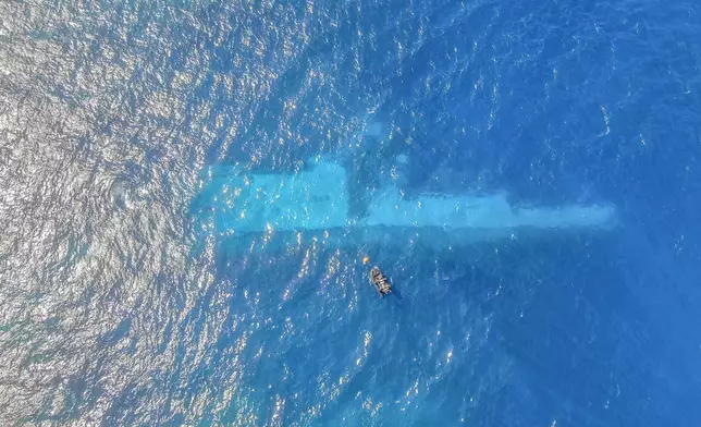 FILE - In this photo provided by the New Zealand Defence Force, divers survey the area around HMNZS Manawanui on the southern coast of Upulo, Samoa, after the Manawanui ran aground and sank on Oct. 6. (AC Jese Somerville/New Zealand Defence Force via AP,File)