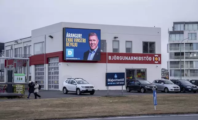 A bilboard of the Independente Party (Sjálfstæðisflokkurinn) with the photo of the current Prime Minister Bjarni Benediktsson reading "Success! Do not turn left", in Reykjavik, Iceland, Friday, Nov. 29, 2024. (AP Photo Marco Di Marco)